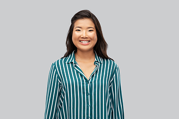 Image showing happy asian woman over grey background