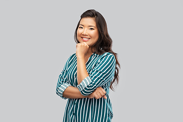 Image showing happy asian woman over grey background