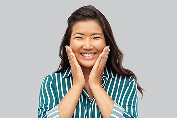 Image showing happy asian woman over grey background