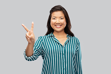 Image showing happy asian woman showing peace hand sign