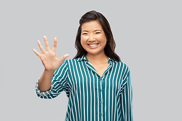 Image showing happy asian woman showing five fingers