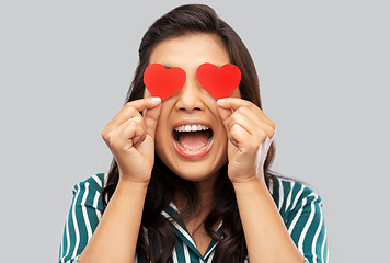 Image showing happy asian woman covering her eyes with red heart