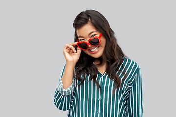 Image showing happy asian woman with in heart shaped sunglasses