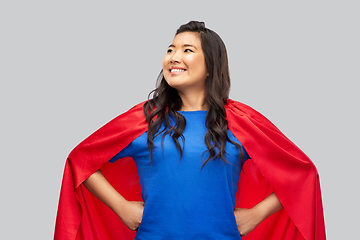 Image showing happy asian woman in red superhero cape