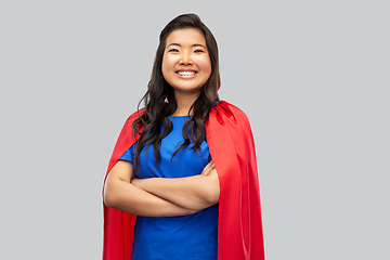 Image showing happy asian woman in red superhero cape