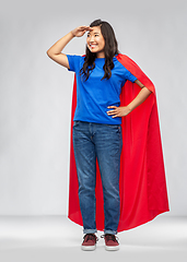 Image showing asian woman in superhero cape looking far away