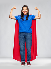 Image showing happy asian woman in red superhero cape