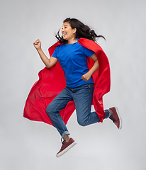 Image showing happy asian woman in red superhero cape jumping