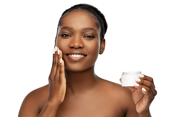 Image showing smiling african american woman with moisturizer