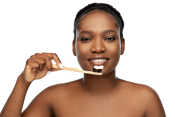 Image showing african woman cleaning teeth with toothbrush