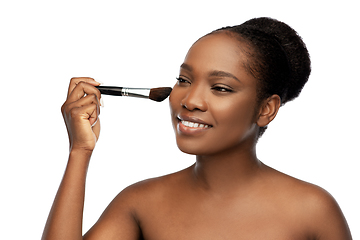 Image showing woman with make up brush applying blush to face