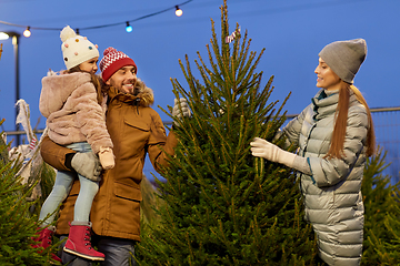 Image showing happy family choosing christmas tree at market