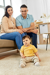 Image showing happy family with child sitting on sofa at home