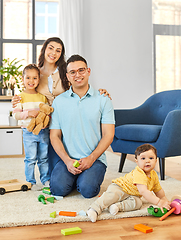 Image showing happy family palying with wooden toys at home