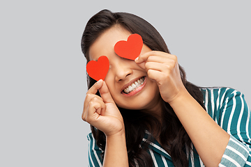 Image showing happy asian woman covering her eyes with red heart