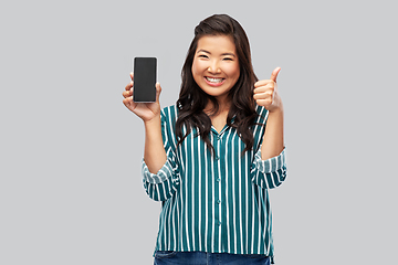 Image showing happy asian woman with smartphone shows thumbs up