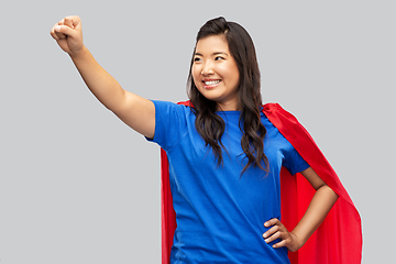 Image showing happy asian woman in red superhero cape