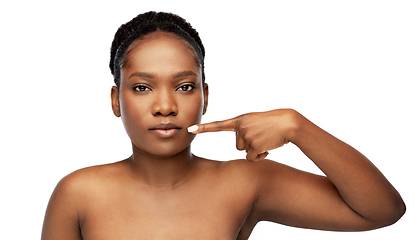 Image showing african american woman pointing to her mouth