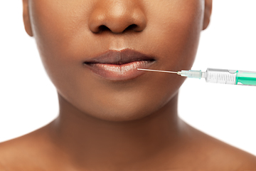 Image showing lips of african american woman and syringe