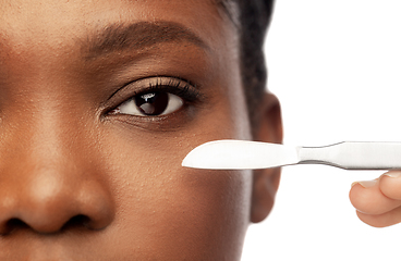 Image showing face of african american woman and scalpel knife