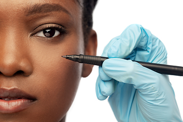 Image showing face of african woman and hand with marker