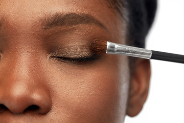 Image showing face of african woman and hand with make up brush