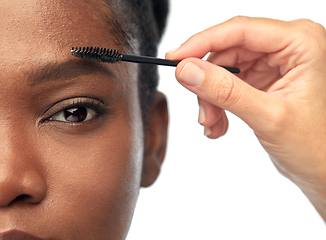 Image showing face of african woman and hand with mascara brush