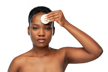 Image showing african woman cleaning face with cotton pad