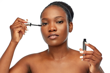 Image showing beautiful african american woman applying mascara