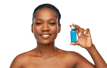 Image showing african american woman with bottle of serum