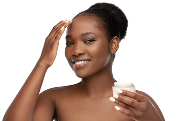 Image showing smiling african american woman with moisturizer