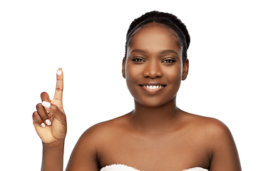 Image showing smiling african american woman with moisturizer