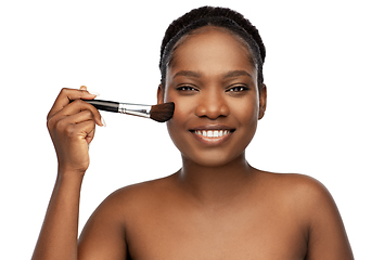 Image showing woman with make up brush applying blush to face