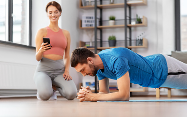 Image showing happy couple exercising at home