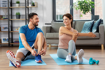 Image showing happy couple exercising at home