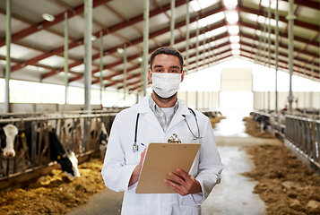 Image showing veterinarian in mask with cows on dairy farm