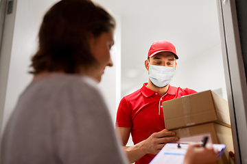 Image showing delivery man in mask with parcel and customer