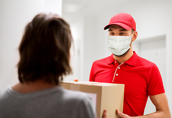 Image showing delivery man in mask giving parcel box to customer