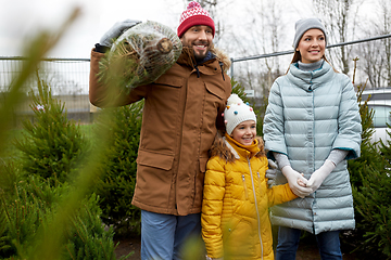 Image showing happy family buying christmas tree at market