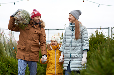 Image showing happy family buying christmas tree at market