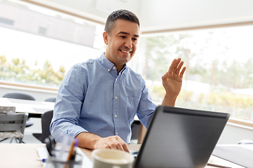 Image showing man with laptop having video call at home office