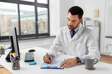 Image showing male doctor with clipboard at hospital