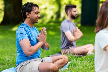 Image showing group of happy people doing yoga at summer park