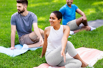 Image showing group of people doing yoga at summer park