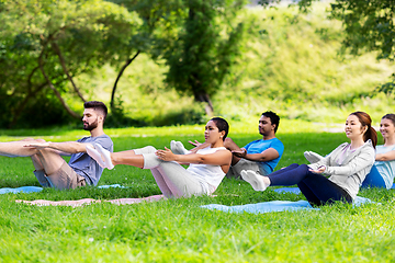 Image showing group of people doing yoga at summer park