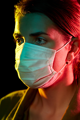 Image showing young woman wearing protective medical mask