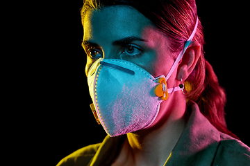 Image showing young woman wearing protective mask or respirator