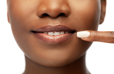 Image showing african american woman pointing to her mouth