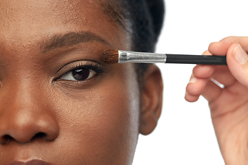 Image showing face of african woman and hand with make up brush