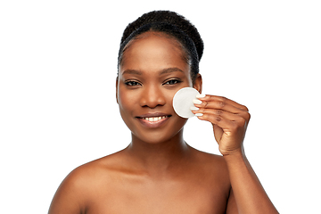 Image showing african woman cleaning face with cotton pad